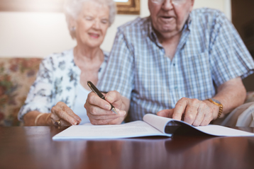 Old couple signing documents — Conveyancing in Northern Territory, NT